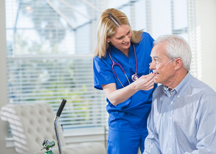 Image of nurse putting on oxygen mask on patient